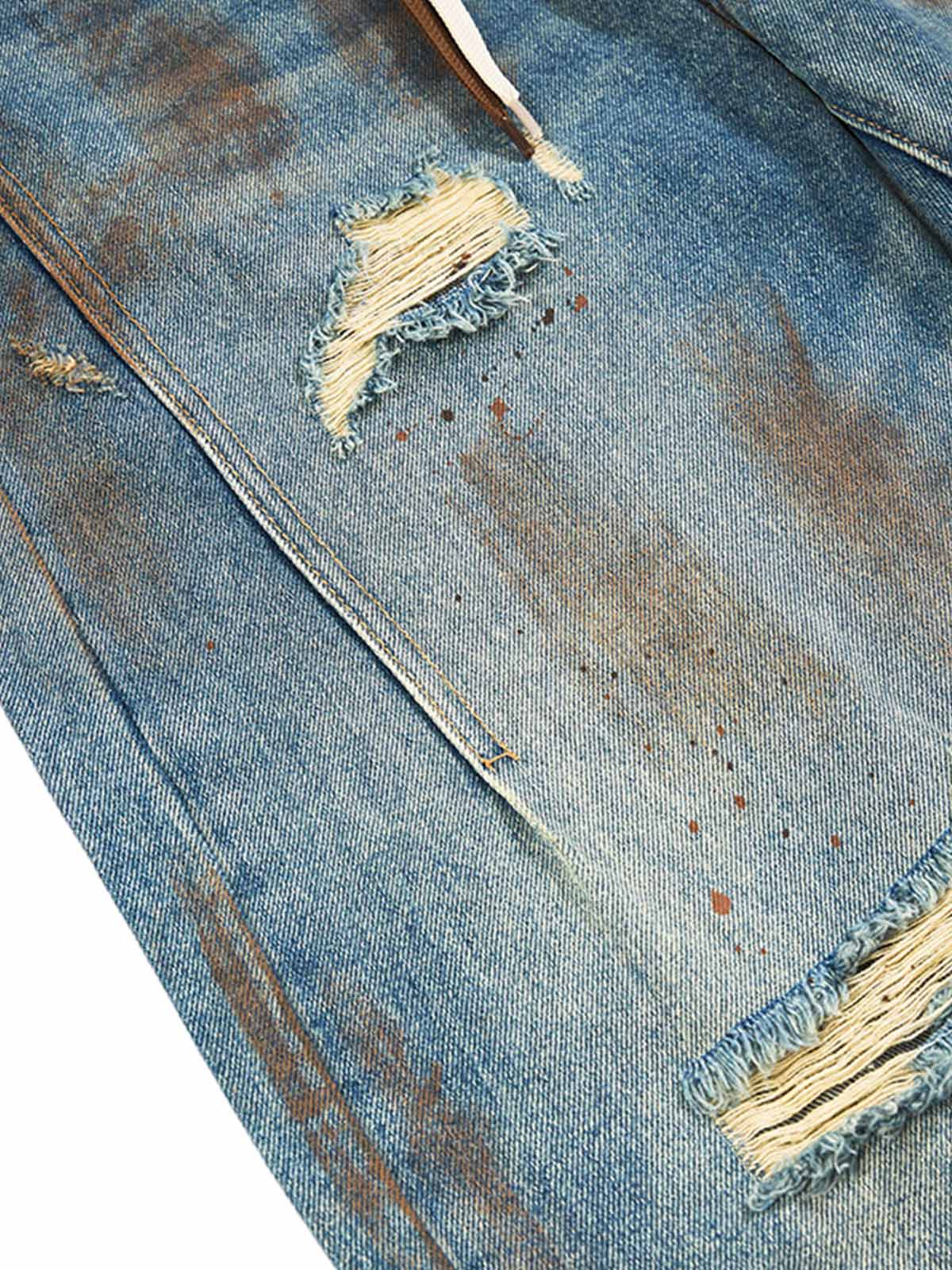 Jean déchiré rétro éclaboussé d'encre