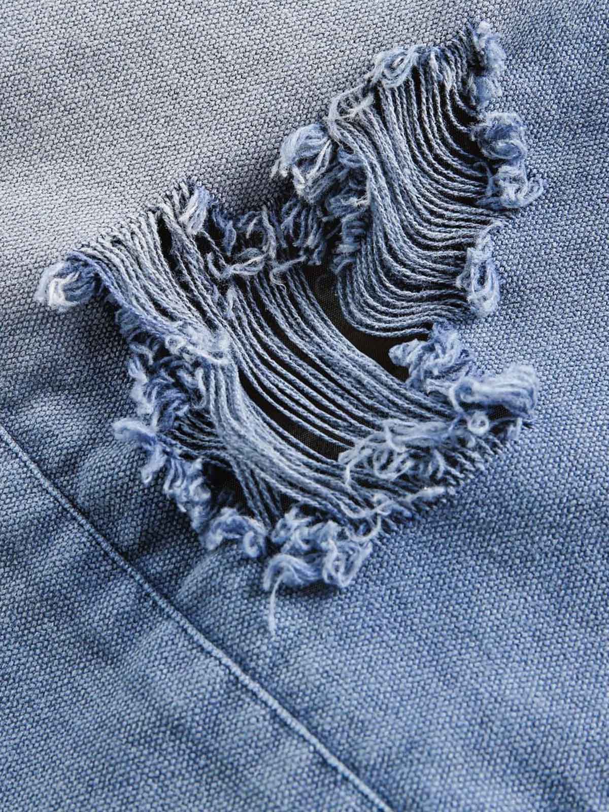 Veste en jean zippée délavée avec graffiti déchiré