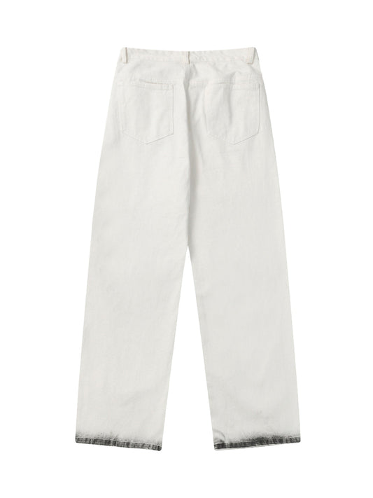 Jeans délavés à taches noires